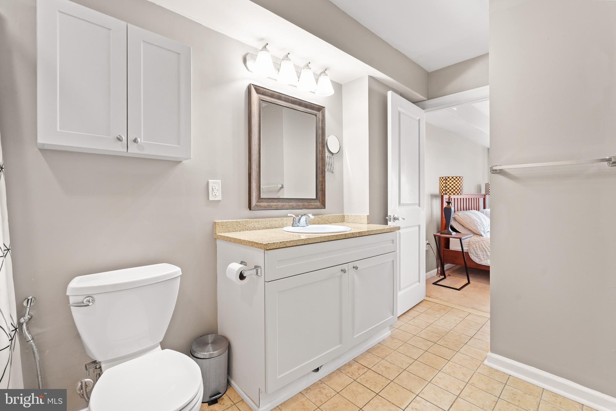5013 The Alameda Baltimore, MD 21239 - Photo 14 of 24 a bathroom with a toilet sink and mirror