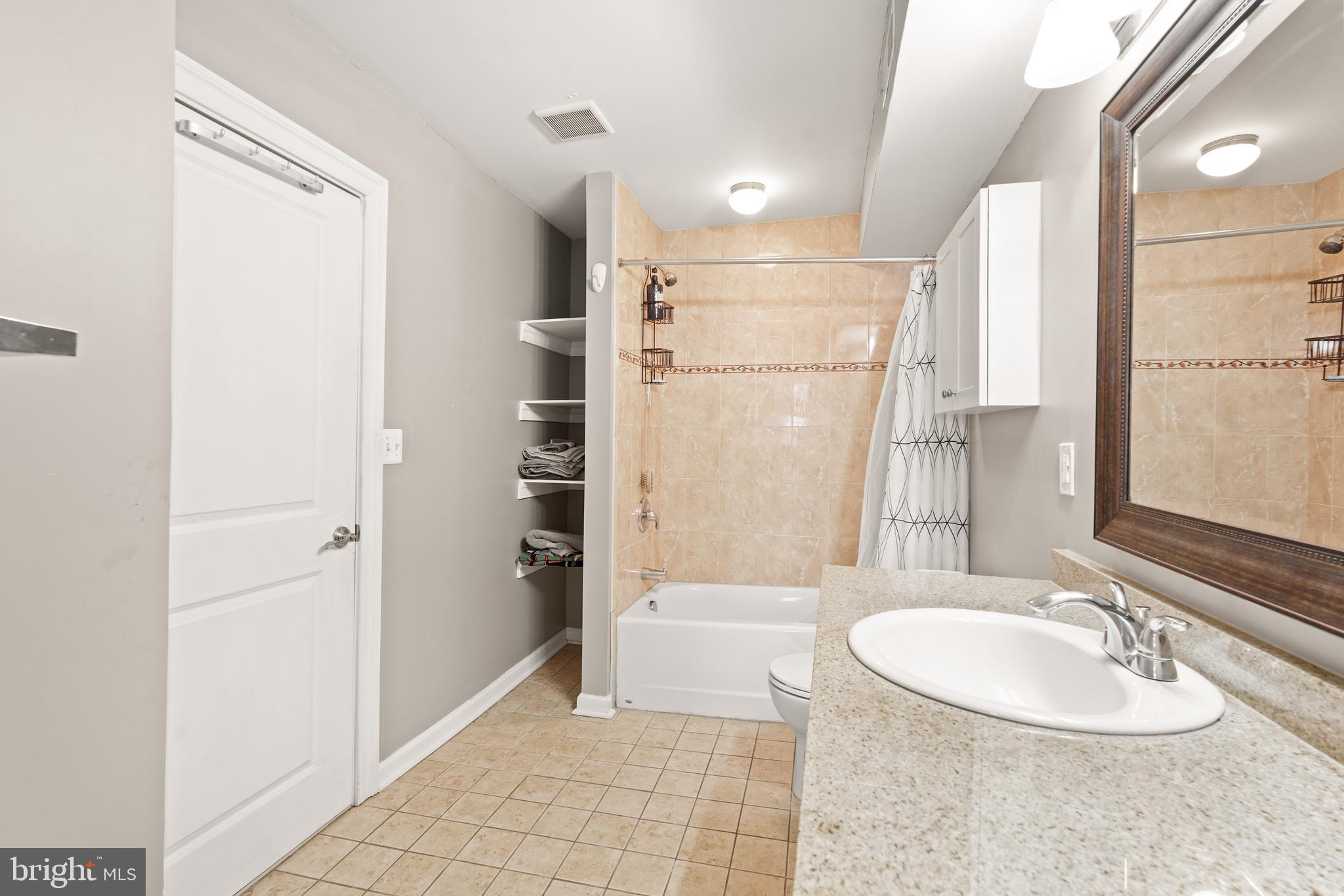 5013 The Alameda Baltimore, MD 21239 - Photo 15 of 24 a bathroom with a sink a toilet and shower