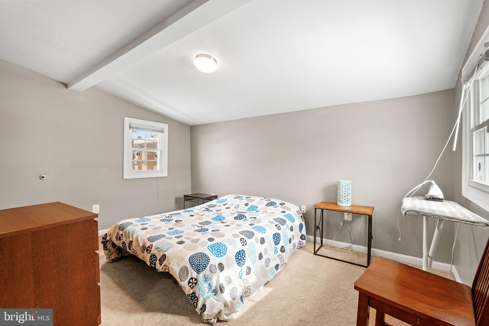 5013 The Alameda Baltimore, MD 21239 - Photo 16 of 24 a bedroom with a bed and a lamp with window