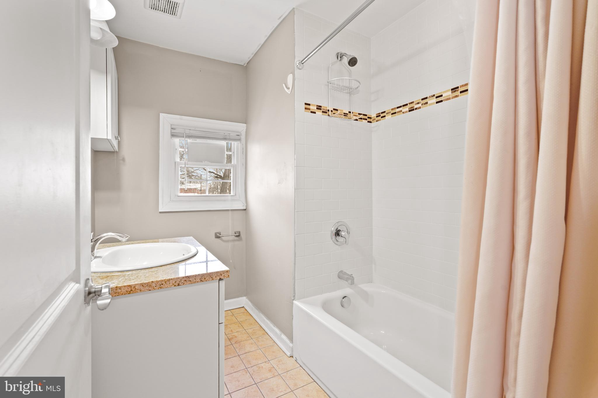 5013 The Alameda Baltimore, MD 21239 - Photo 18 of 24 a bathroom with a tub a sink and a mirror