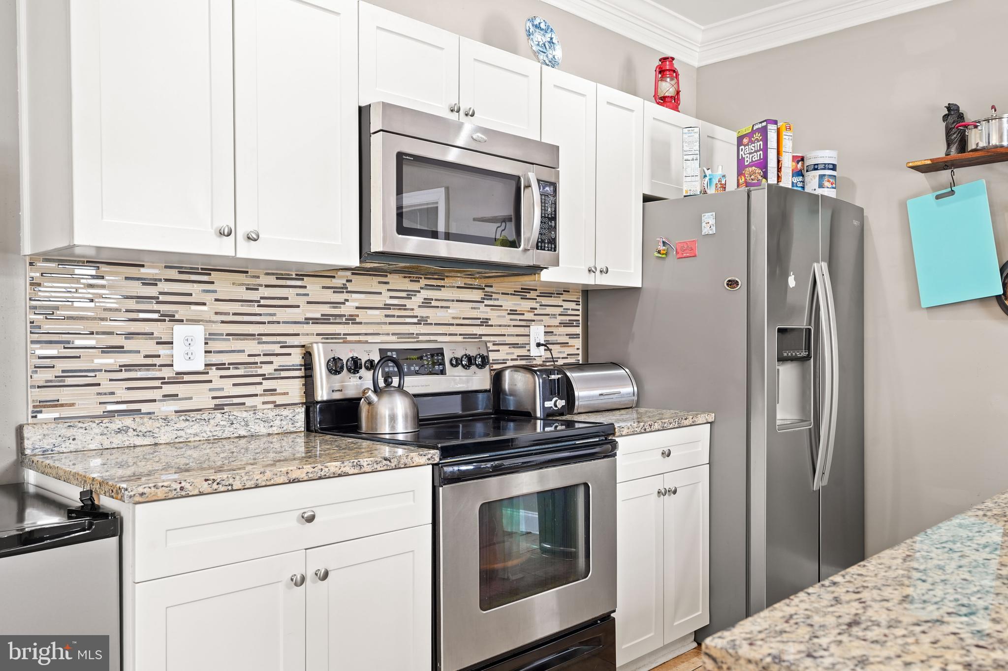 5013 The Alameda Baltimore, MD 21239 - Photo 5 of 24 a kitchen with stainless steel appliances granite countertop a refrigerator stove and sink