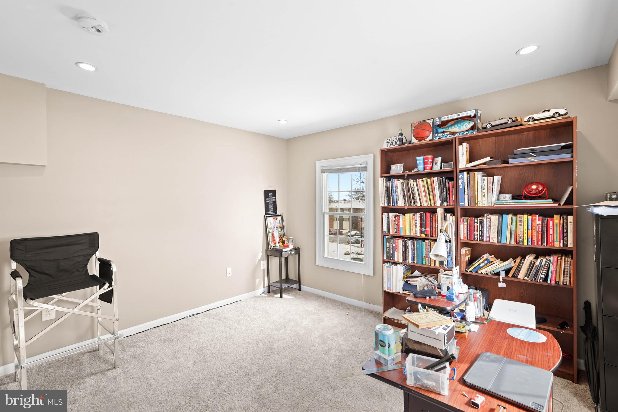 5013 The Alameda Baltimore, MD 21239 - Photo 10 of 24 a living room with furniture a book shelf and a book shelf