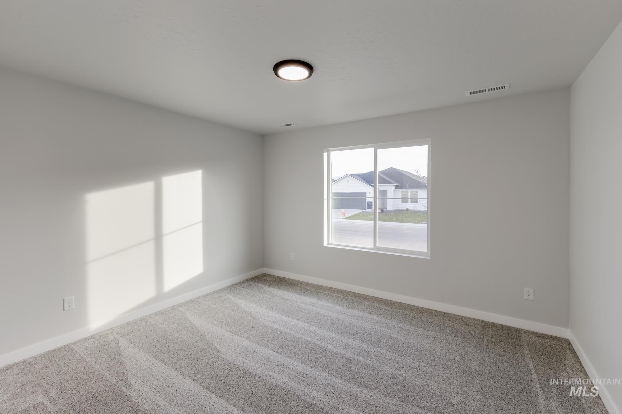 1716 North Birch Street Jerome, ID 83338 - Photo 8 of 16 Empty room featuring carpet flooring and baseboards