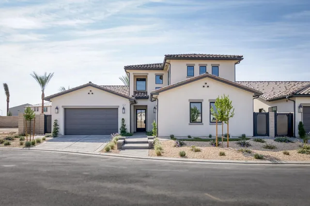 a view of a house with a yard and garage