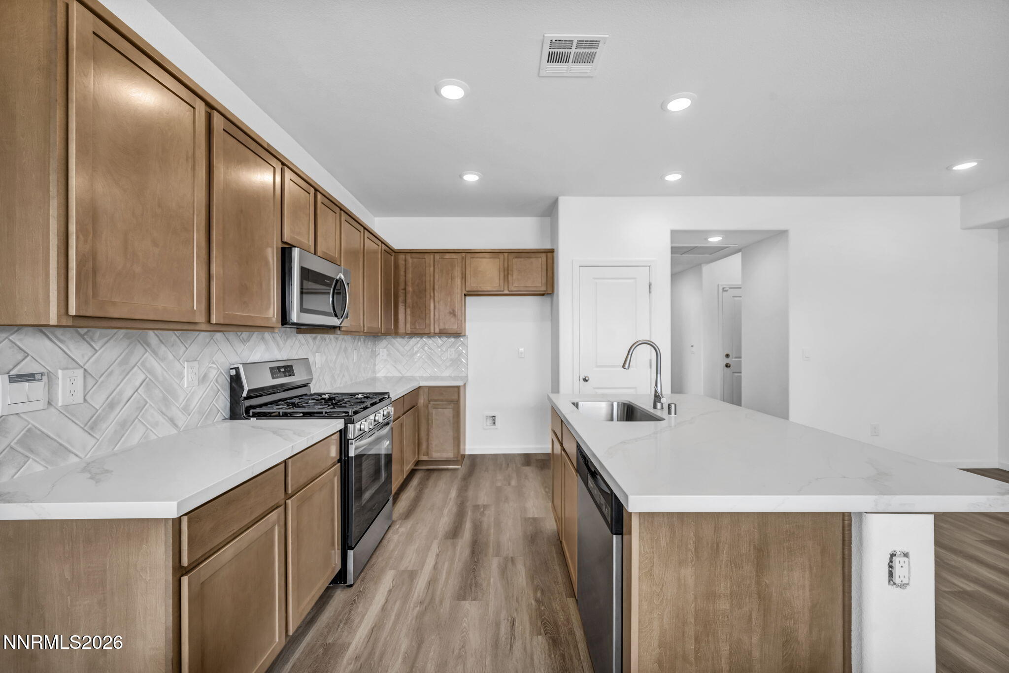 6676 Morgan Mill Road, Unit HOMESITE 14 Carson City, NV 89701 - Photo 3 of 24 a kitchen with stainless steel appliances granite countertop sink stove refrigerator and cabinets