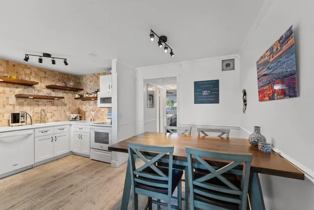 a view of a dining room with furniture and wooden floor