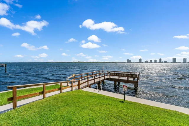 a view of a roof deck with two couches and wooden floor