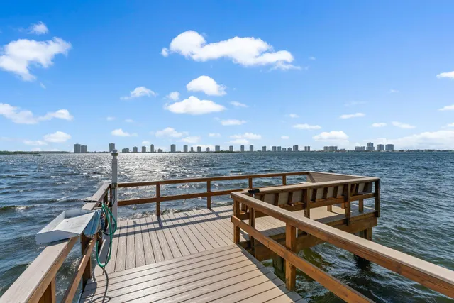 a view of a swimming pool with lawn chairs and a fire pit