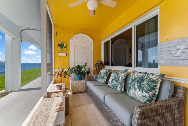 a balcony with furniture and a potted plant