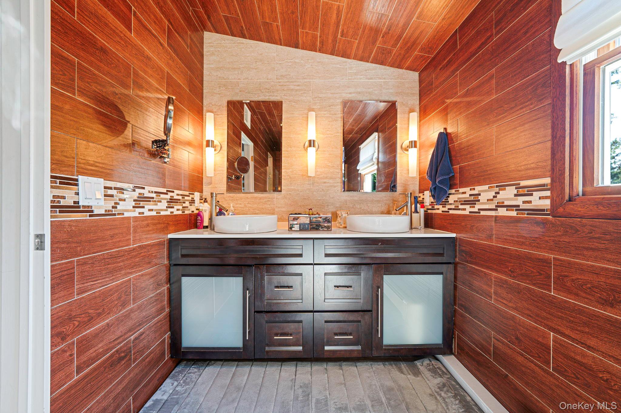183 Old Country Road Speonk, NY 11972 - Photo 15 of 48 Full bathroom featuring double vanity, vaulted ceiling, and tile walls