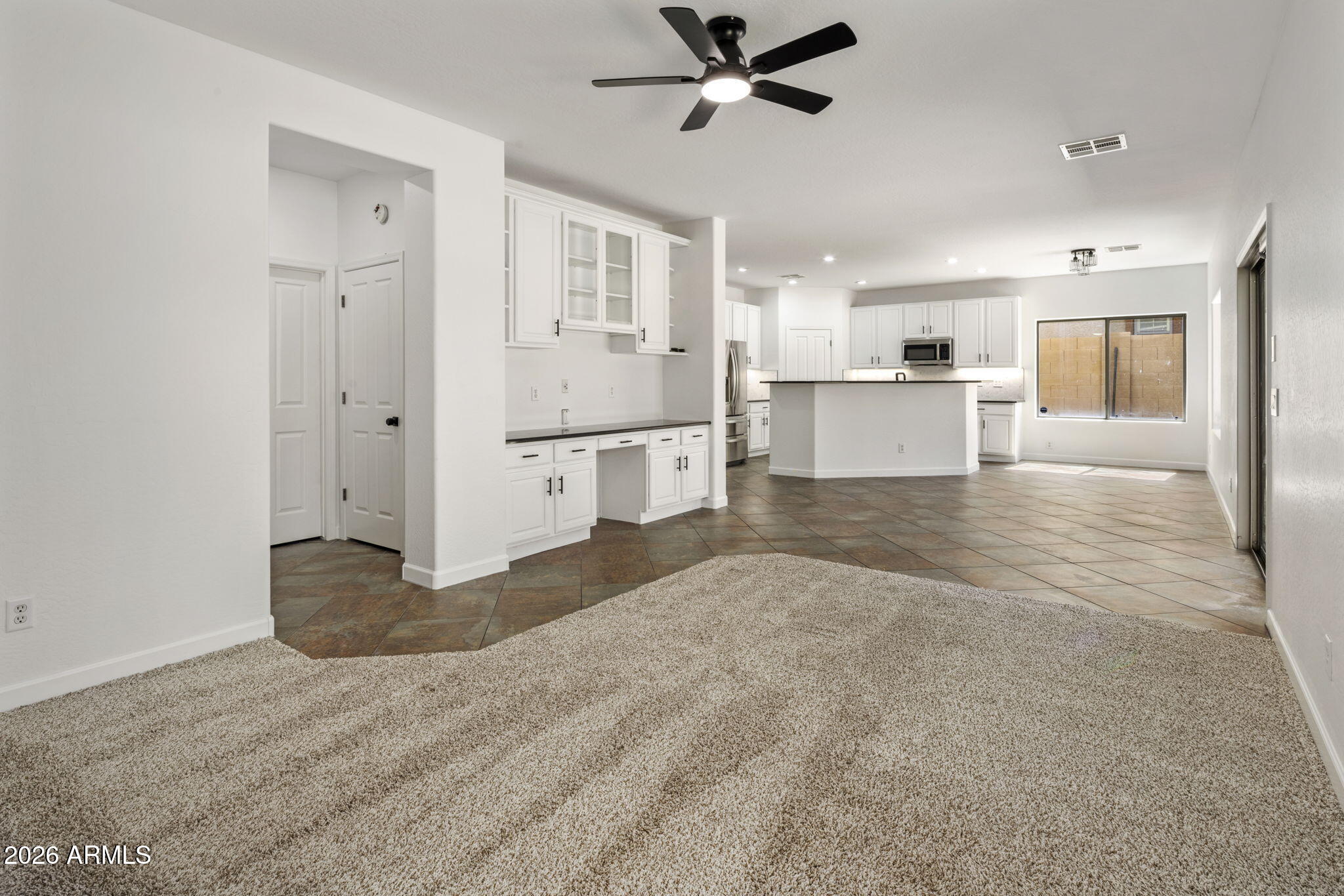 5121 West Beverly Road Laveen, AZ 85339 - Photo 14 of 32 a view of a kitchen with a refrigerator and windows