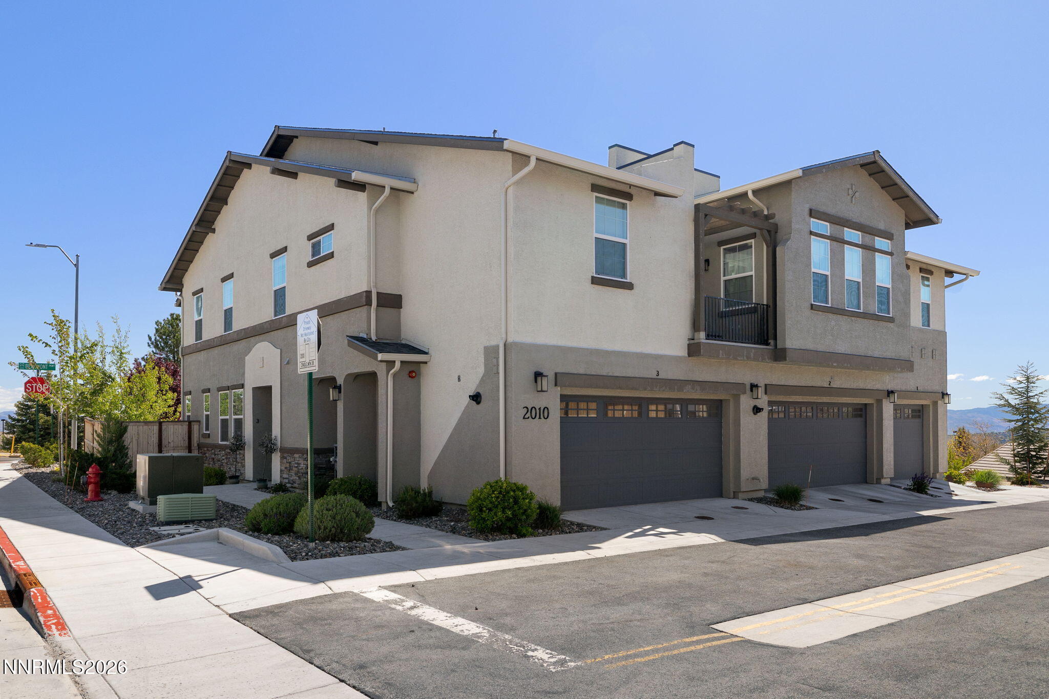 2010 Cradle Mountain Drive, Unit 3 Reno, NV 89523 - Photo 2 of 31 a front view of a house with a yard and garage