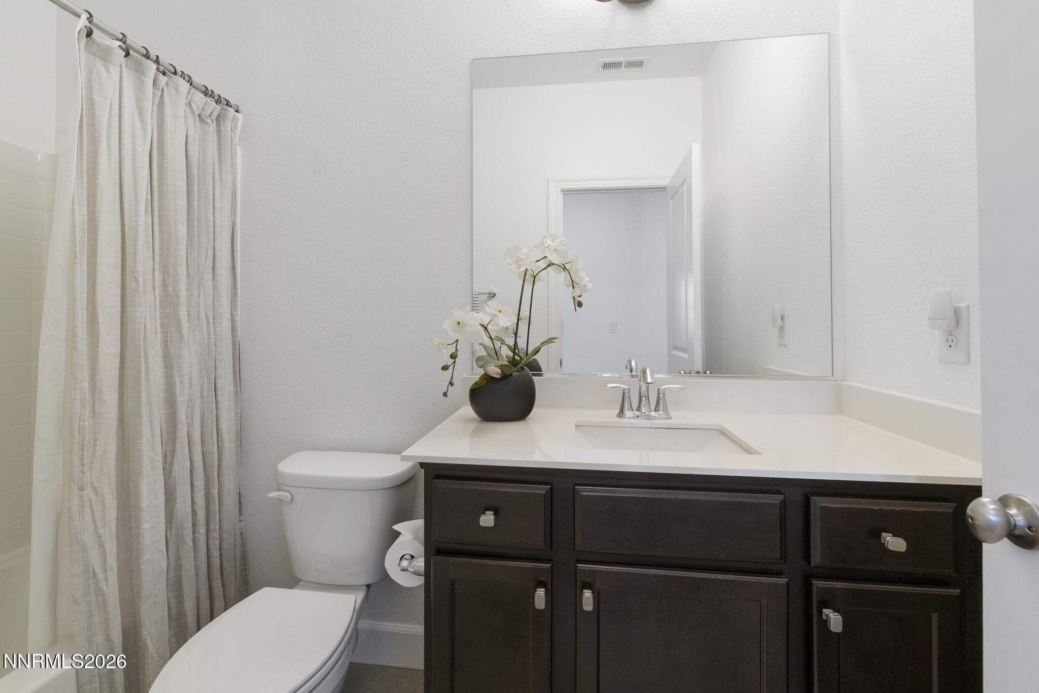 2010 Cradle Mountain Drive, Unit 3 Reno, NV 89523 - Photo 24 of 31 a bathroom with a sink a toilet and mirror
