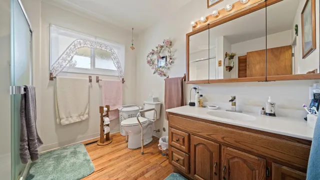 a bathroom with a sink a mirror and a shower