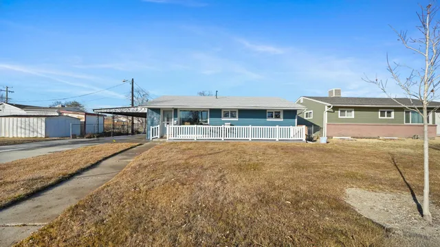 a view of a large building with a big yard and large trees