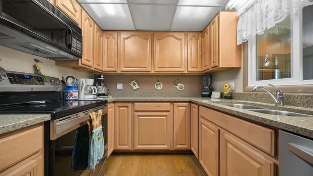 a kitchen with stainless steel appliances granite countertop a sink and cabinets