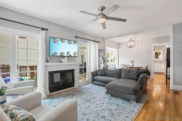 a living room with furniture a large window and a fireplace