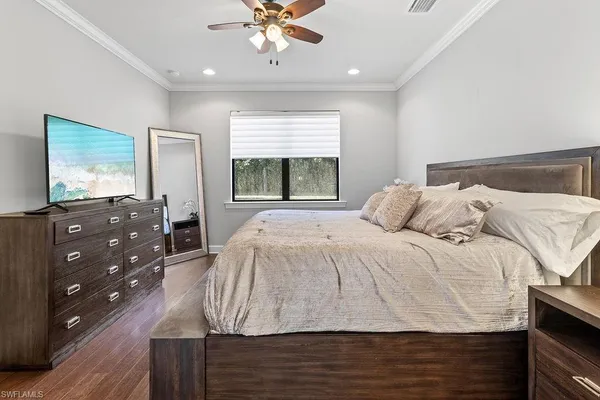 a bedroom with a large bed and a window