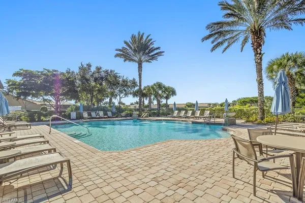 a view of a swimming pool and a lawn chairs