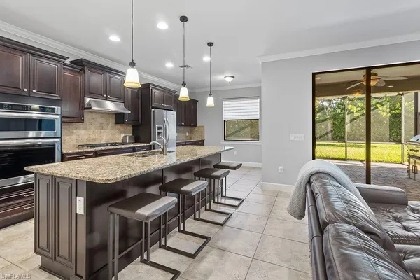a kitchen with cabinets and stainless steel appliances