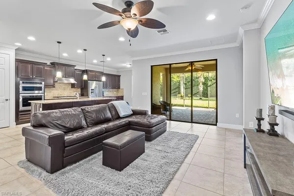 a kitchen with kitchen island a large counter top space appliances and windows