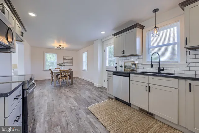 a kitchen with sink cabinets and wooden floor