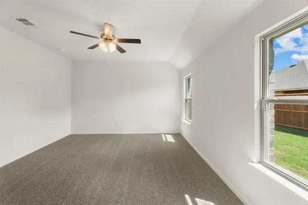 a view of a livingroom with a ceiling fan and window