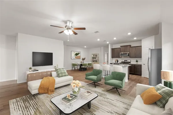 a living room with furniture kitchen view and a chandelier
