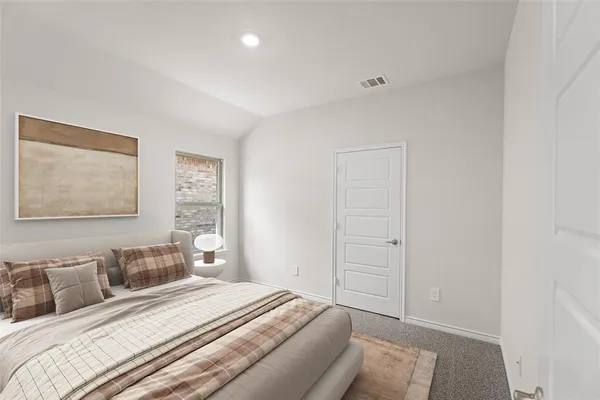 a bedroom with a bed and a painting on the wall