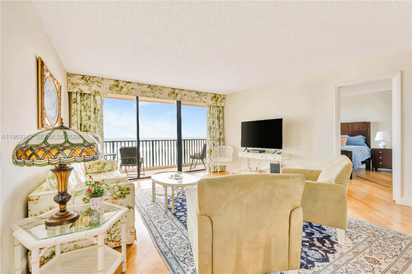 300 Ocean Trail Way, Unit 1008 Jupiter, FL 33477 - Photo 19 of 34 a living room with furniture and a flat screen tv