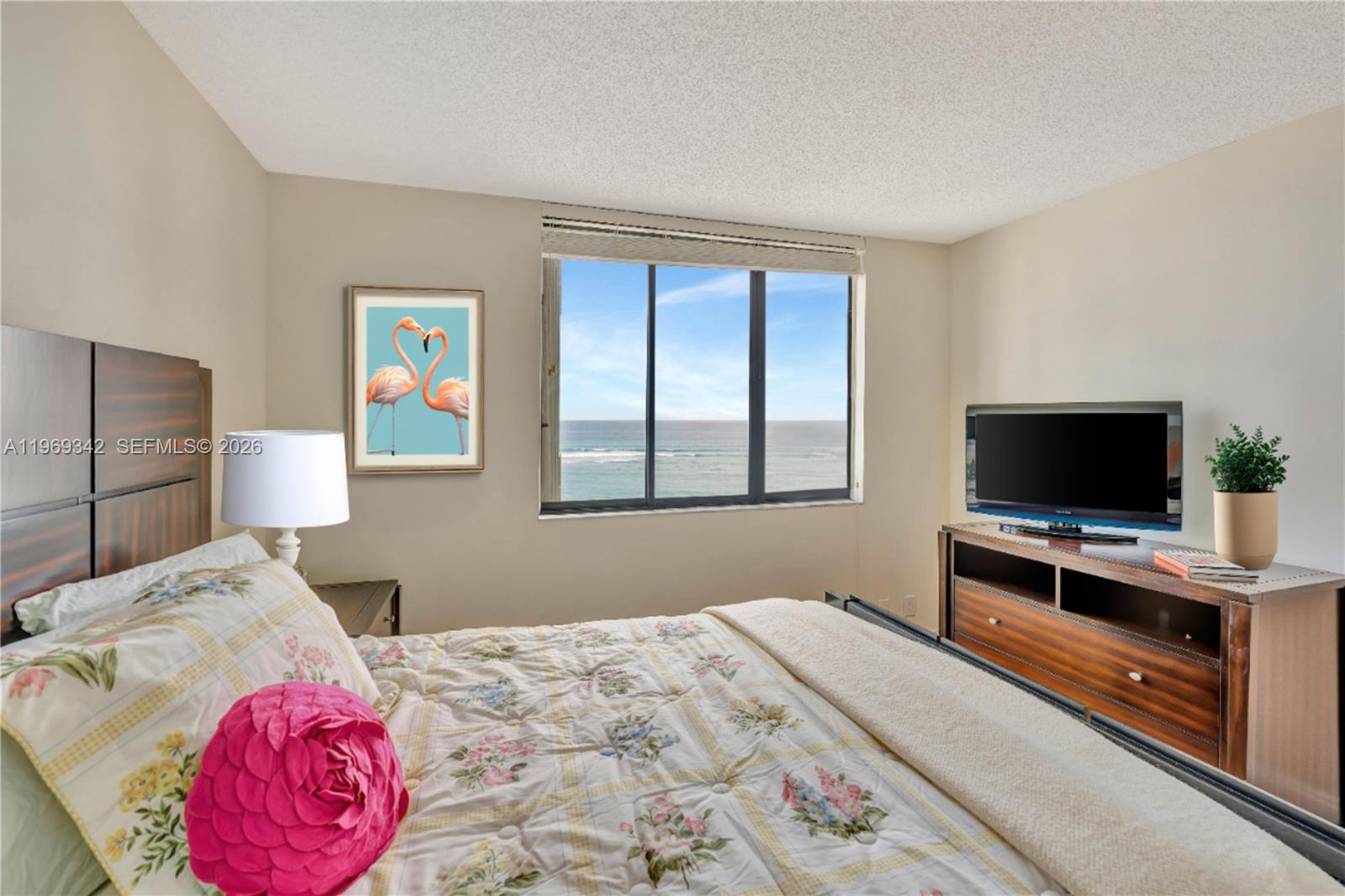 300 Ocean Trail Way, Unit 1008 Jupiter, FL 33477 - Photo 20 of 34 a bedroom with a bed and a flat screen tv