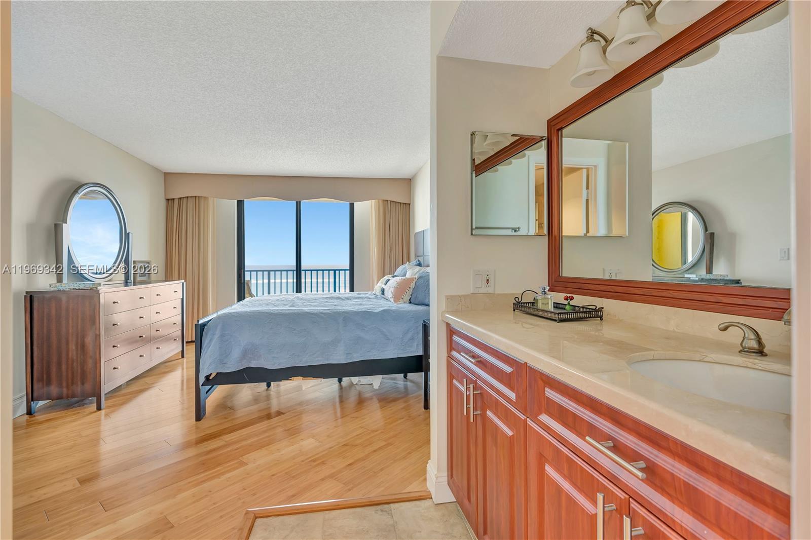 300 Ocean Trail Way, Unit 1008 Jupiter, FL 33477 - Photo 10 of 34 a bedroom with a bed and a dresser with mirror