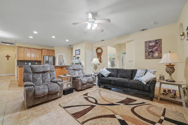 a kitchen with granite countertop a sink a stove and cabinets