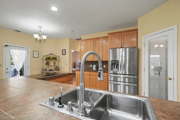 a kitchen with stainless steel appliances granite countertop a refrigerator sink and cabinets