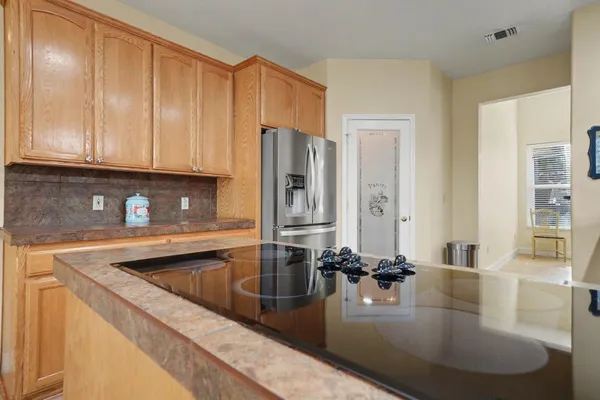 a kitchen with stainless steel appliances granite countertop a sink and a refrigerator