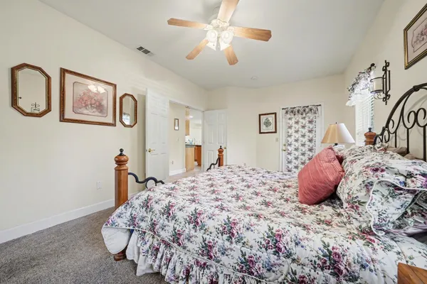a spacious bedroom with a bed and a large window