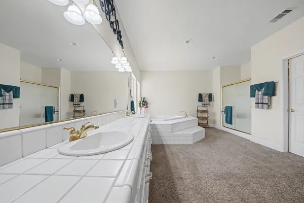 a bed room with a bed and a chandelier