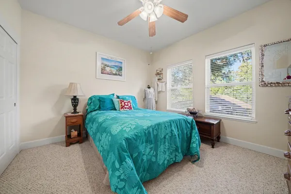 a view of a room with closet and ceiling fan