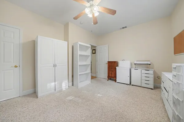 a view of a house with a small yard and a patio
