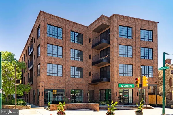 an aerial view of a multi story building with a yard