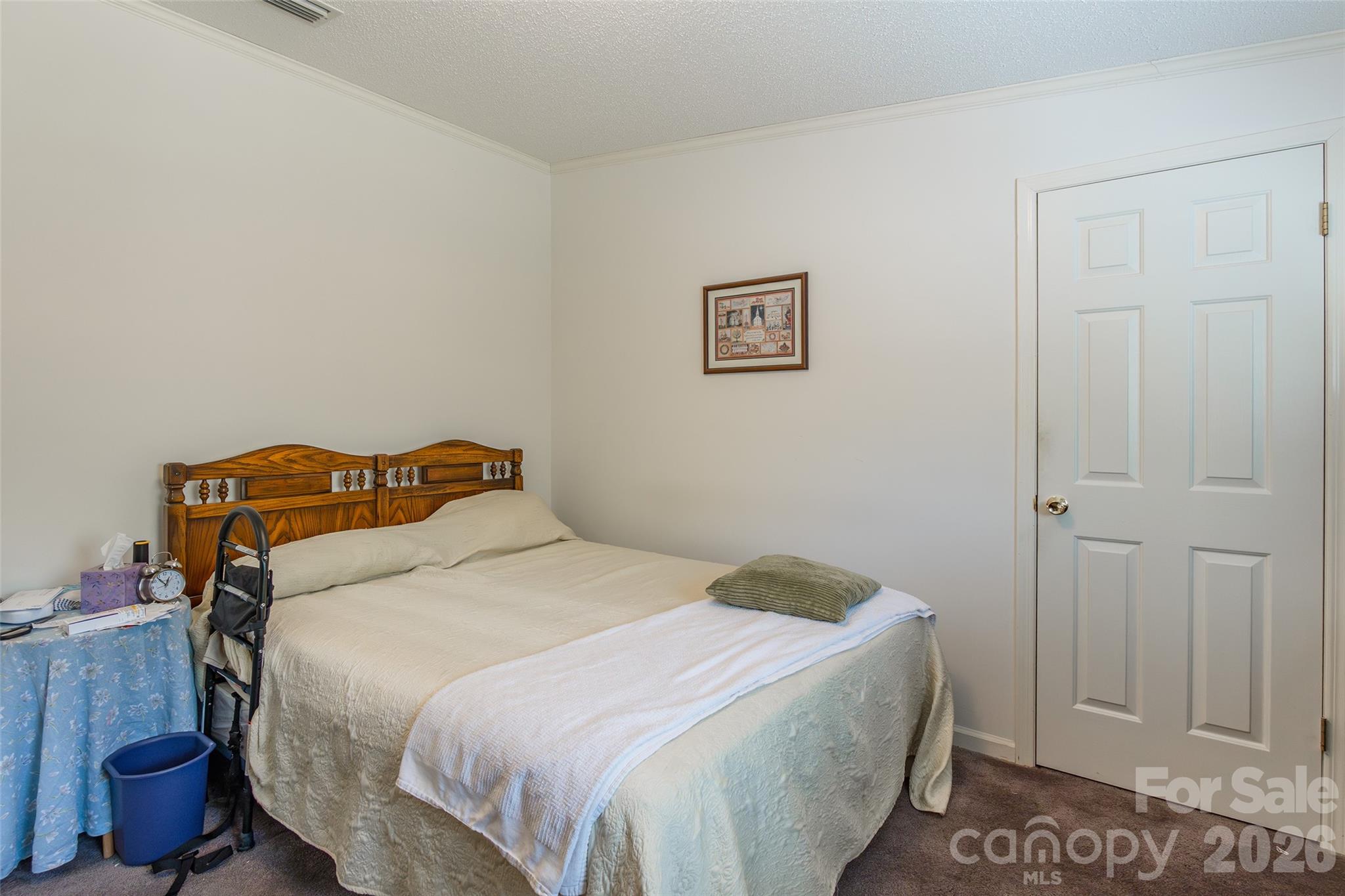 777 John Doster Road Pageland, SC 29728 - Photo 25 of 34 a bedroom with a bed and a lamp on the dresser