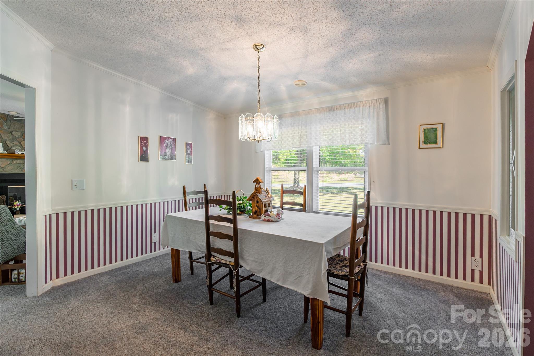 777 John Doster Road Pageland, SC 29728 - Photo 8 of 34 a view of a dining room and hall with furniture window and wooden floor