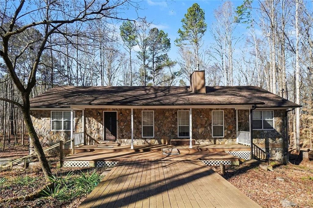a view of a house with a backyard and a patio