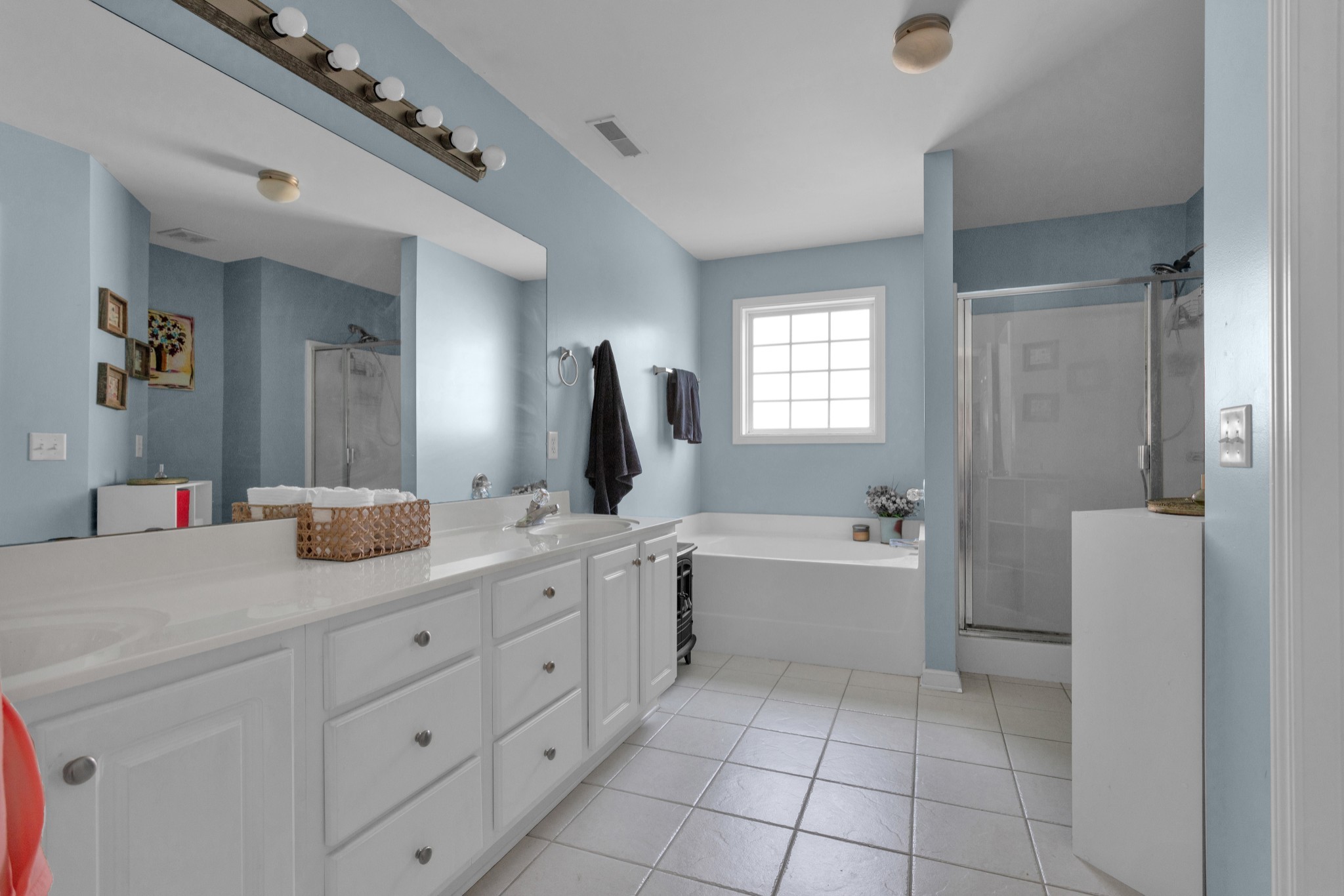 2105 Burgess Lane Spring Hill, TN 37174 - Photo 21 of 36 a spacious bathroom with a granite countertop sink a toilet a mirror and bathtub