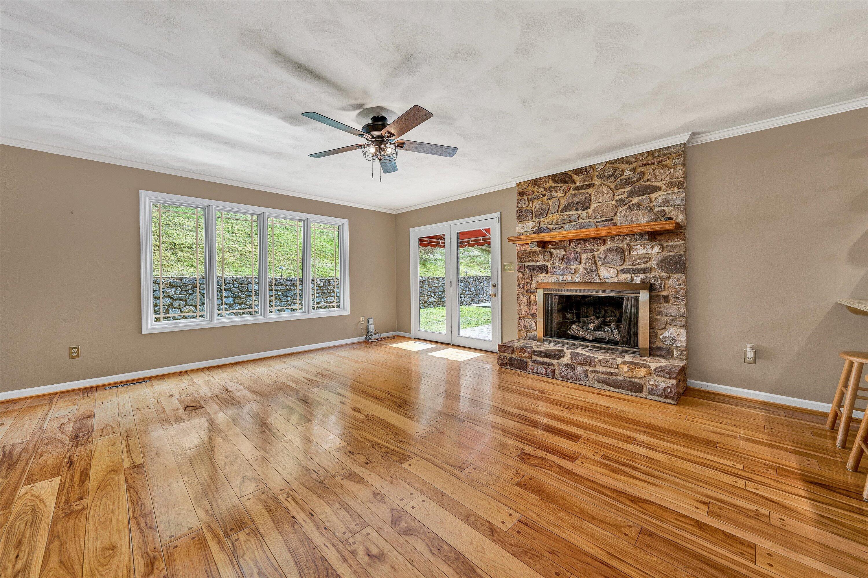 29 Serenity Lane Blue Ridge, VA 24064 - Photo 18 of 81 a view of an empty room with wooden floor fireplace and a window