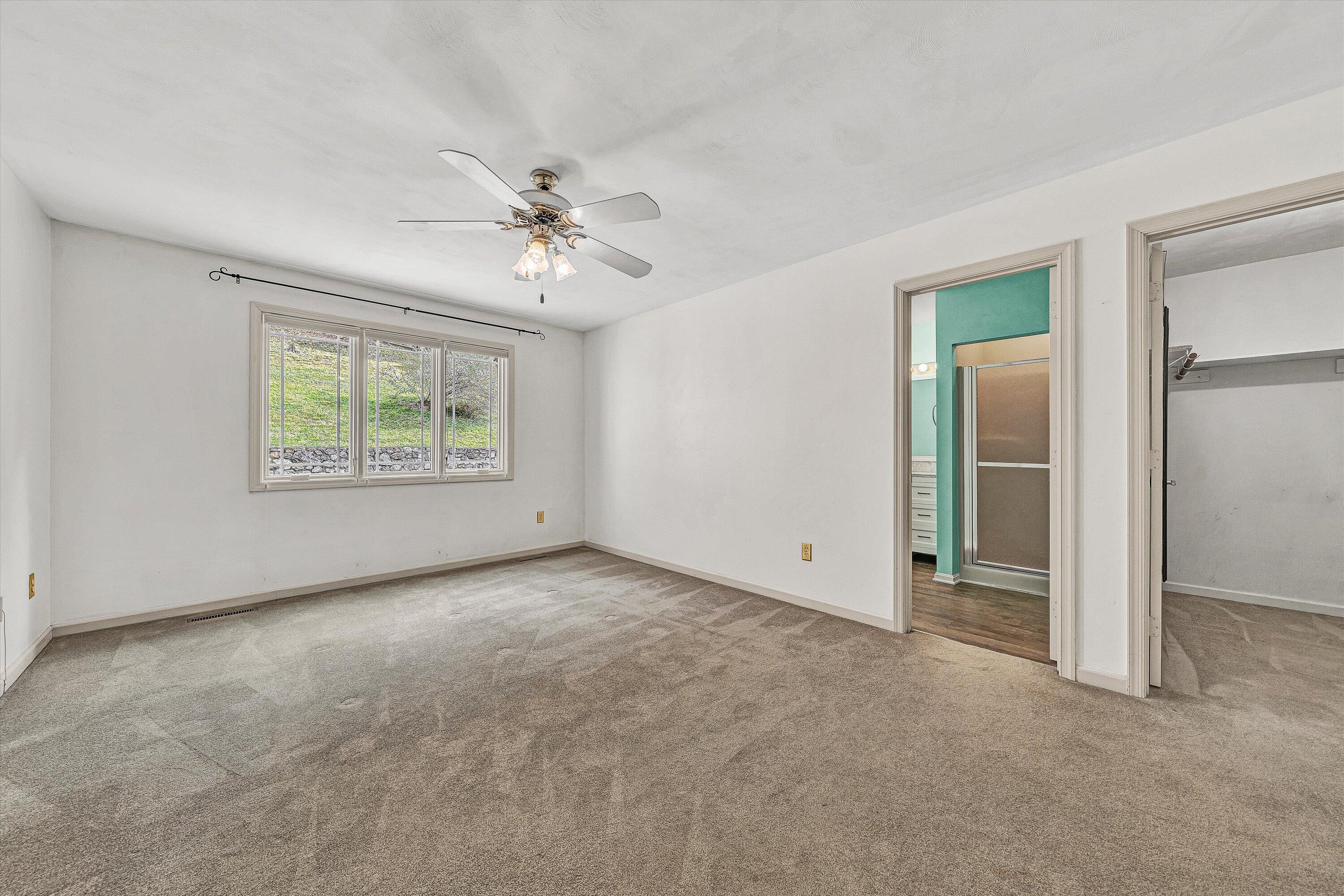 29 Serenity Lane Blue Ridge, VA 24064 - Photo 22 of 81 an empty room with chandelier fan and windows