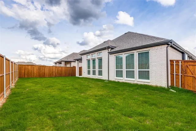 a view of a yard in front of a house with a large garden