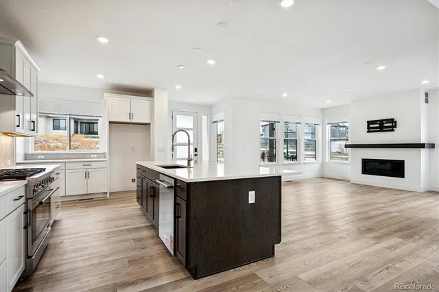 a kitchen with stainless steel appliances a stove top oven and sink