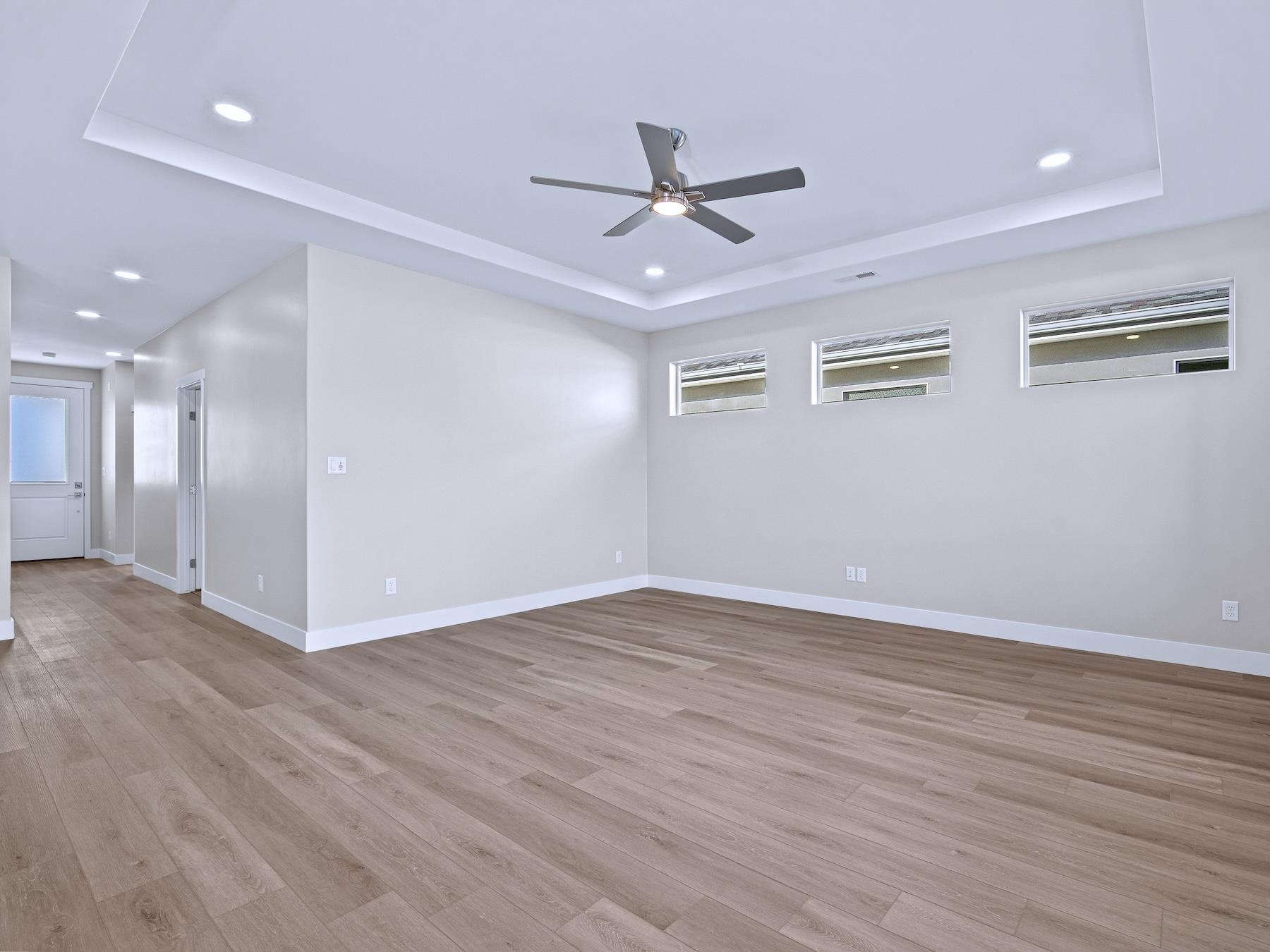 2952 Apollo Drive Grand Junction, CO 81504 - Photo 11 of 27 a view of an empty room with wooden floor and a ceiling fan