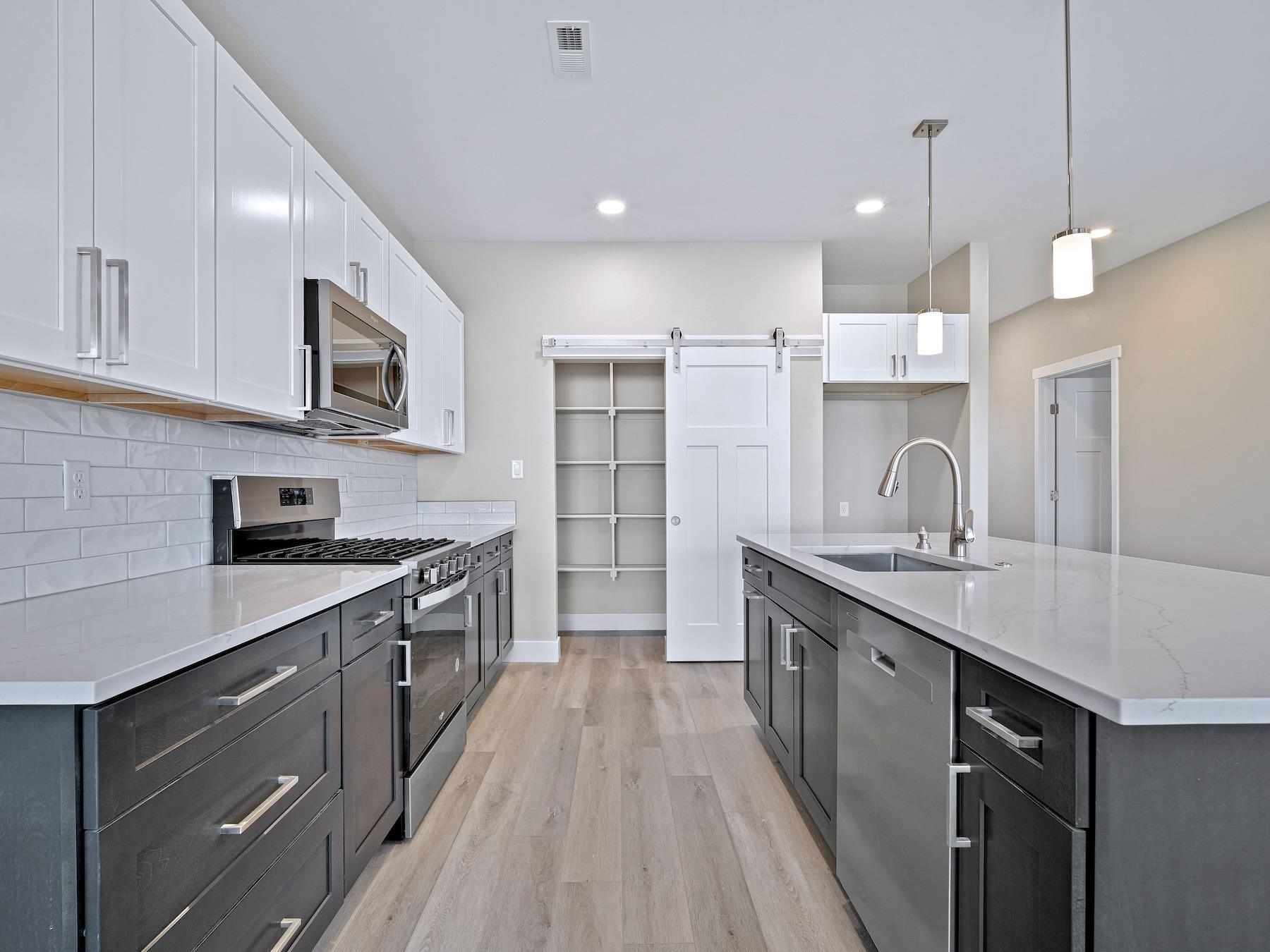 2952 Apollo Drive Grand Junction, CO 81504 - Photo 5 of 27 a kitchen with stainless steel appliances granite countertop a sink stove and refrigerator